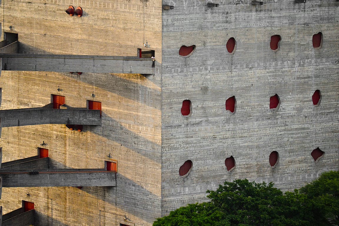 A concrete building with oddly shaped windows.